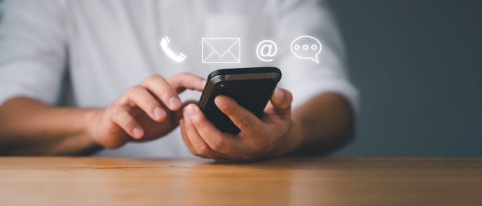 Customer support hotline Contact us people connection. Businessman using Smart Phone with the email, call phone, address, Chat message icons.